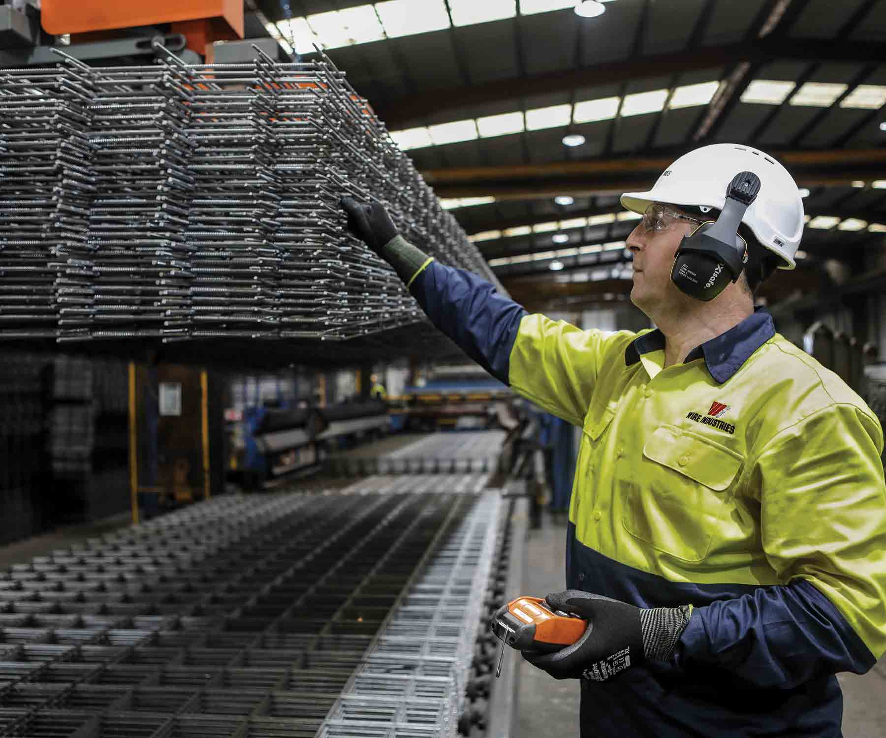 Wire Industries employee inspecting reinforcing mesh