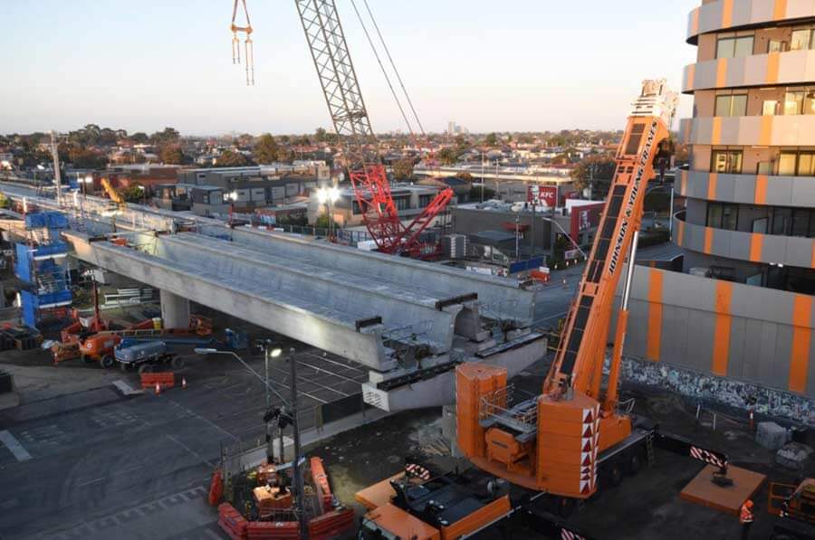 Cranes constructing rail bridge