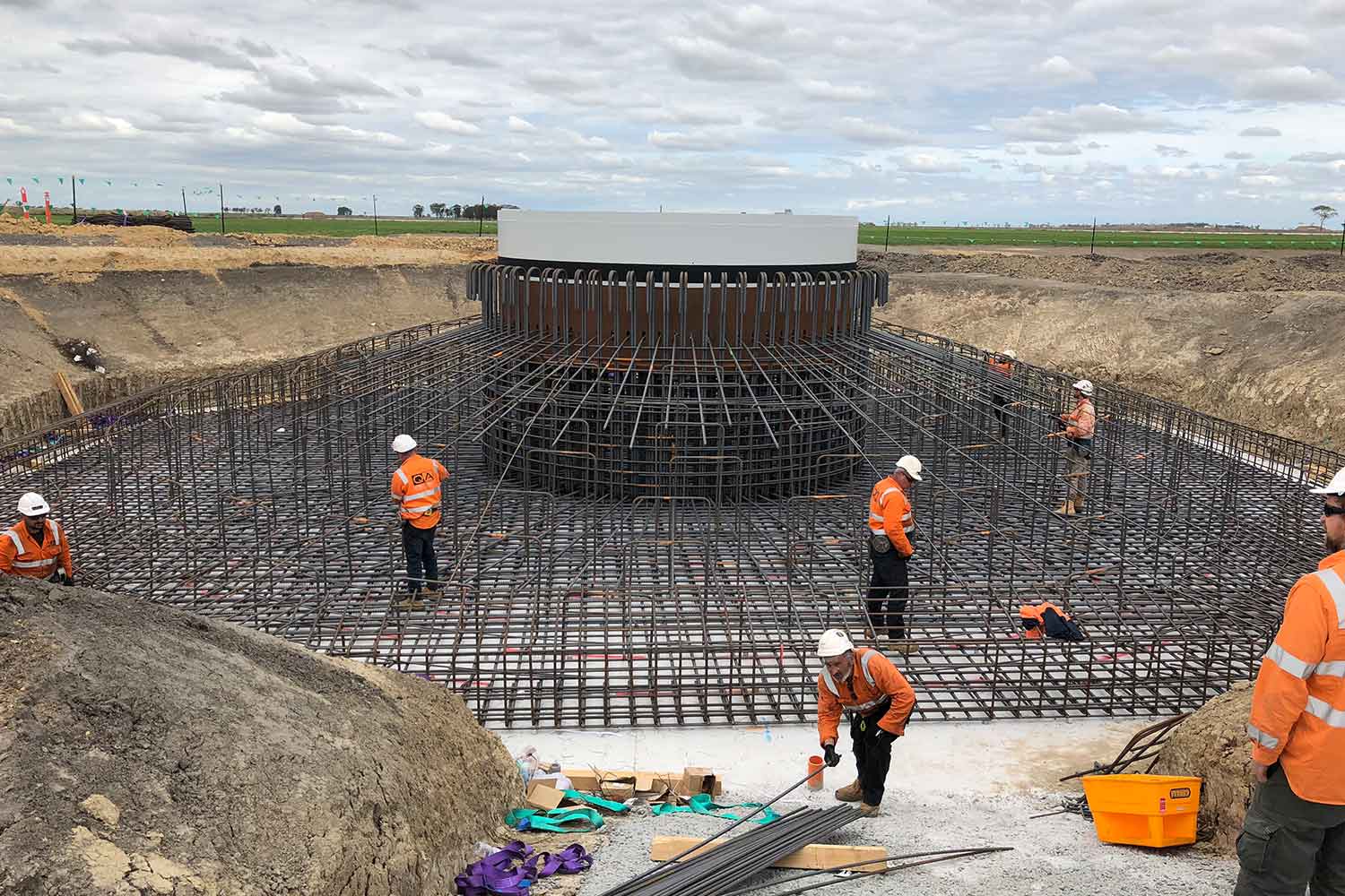 Construction workers laying out reinforcing bars